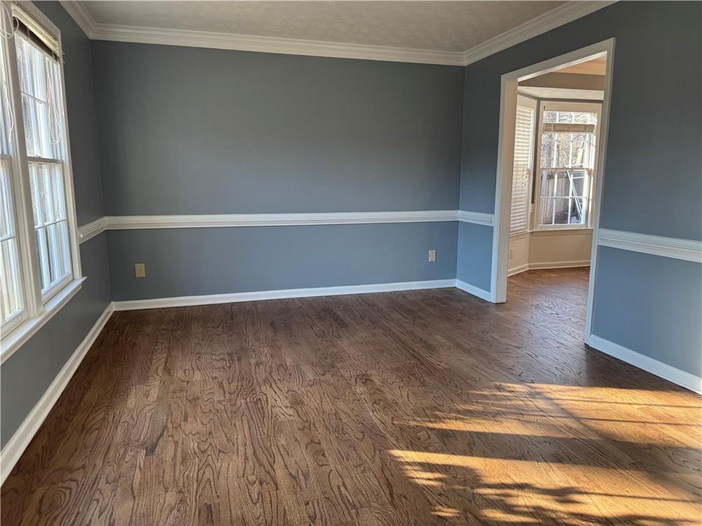 3205 Ivy Station Drive Duluth, GA 30096 - Photo 6 of 38 a view of an empty room with wooden floor and a window