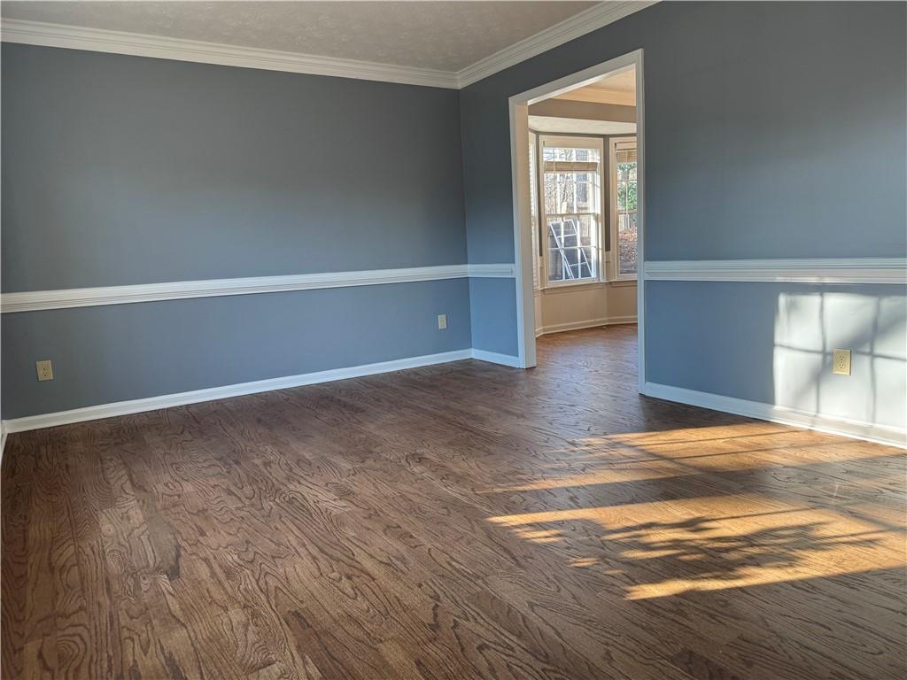 3205 Ivy Station Drive Duluth, GA 30096 - Photo 7 of 38 a view of an empty room with window and wooden floor