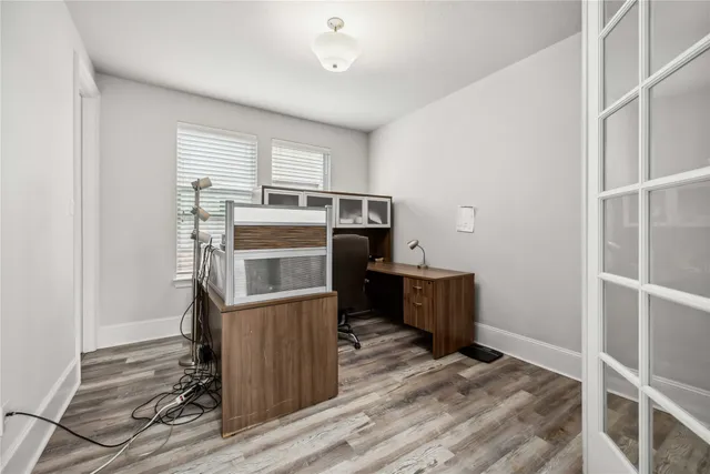 a kitchen with stainless steel appliances wooden floor and window