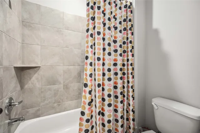 a bathroom with a bathtub and a toilet