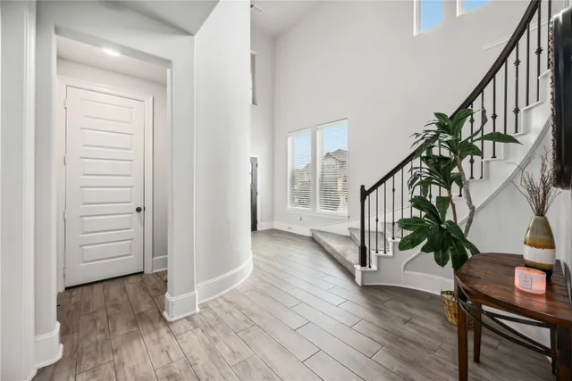 a view of entryway with wooden floor and stairs