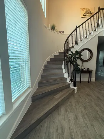 a view of entryway and hall with wooden floor