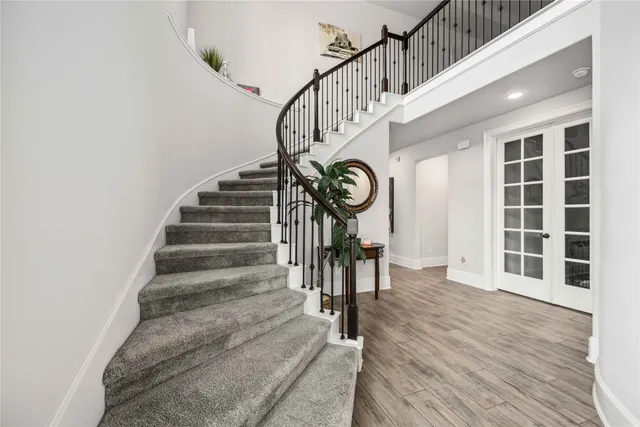 a view of entryway and hall with wooden floor