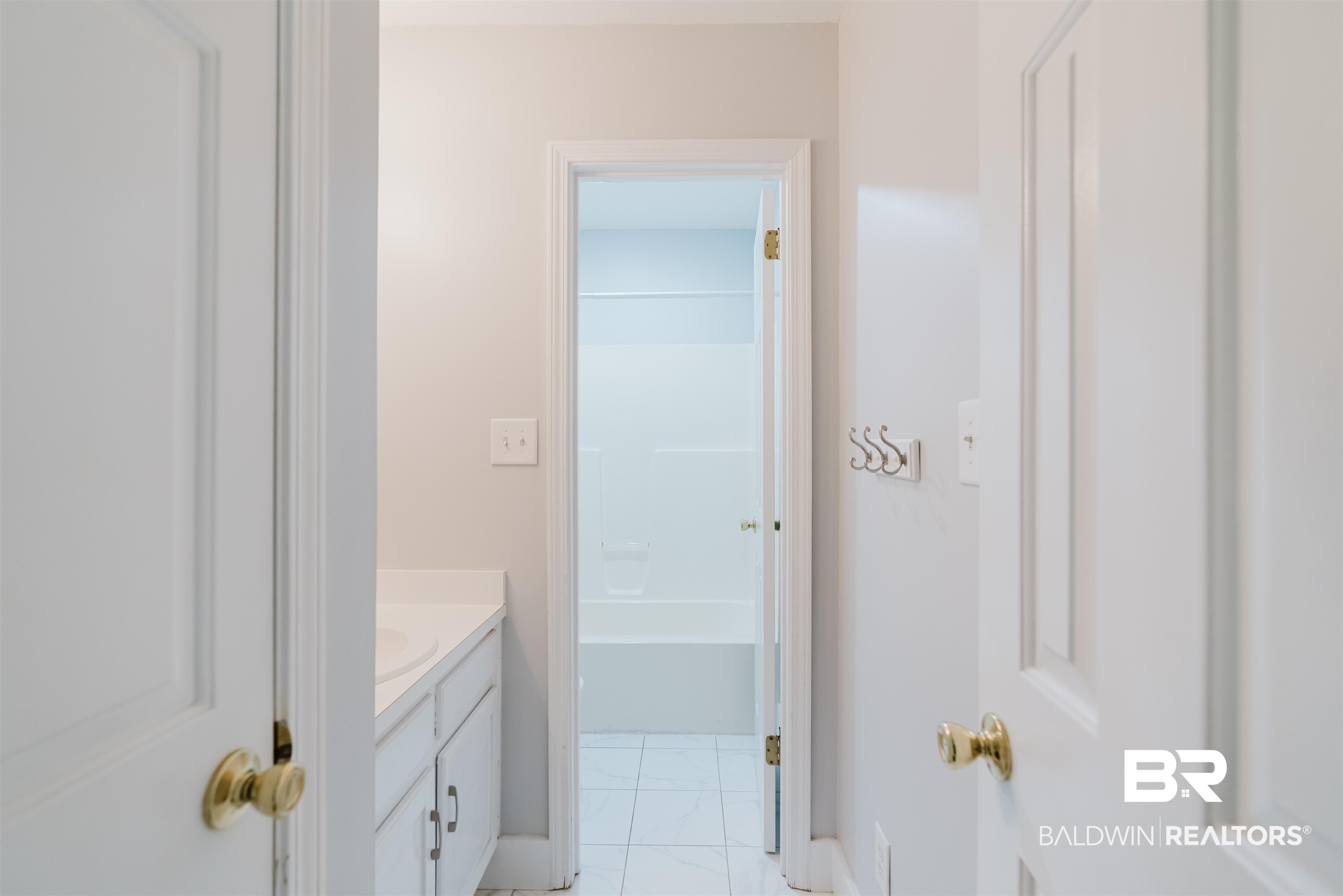 20460 Bishop Road Fairhope, AL 36532 - Photo 23 of 41 Bathroom featuring vanity, marble look tile flooring, and baseboards