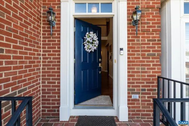 a view of a door and brick walls