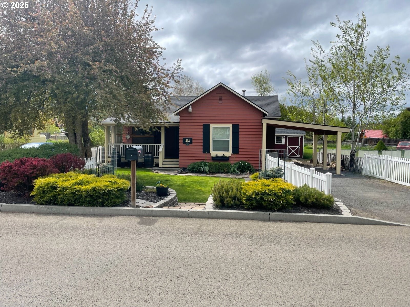 a front view of a house with a yard and outdoor seating