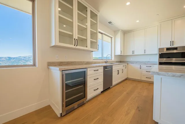 a kitchen with stainless steel appliances granite countertop a stove and a sink