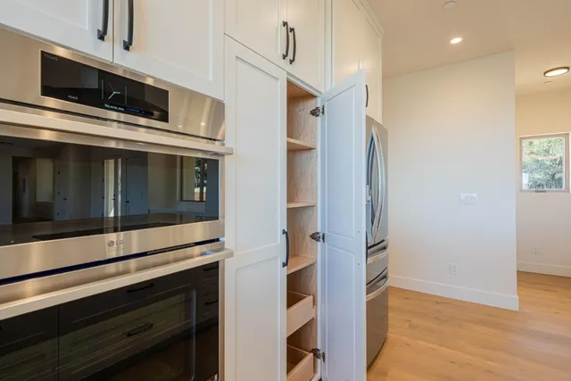 a kitchen with stainless steel appliances a stove and a refrigerator