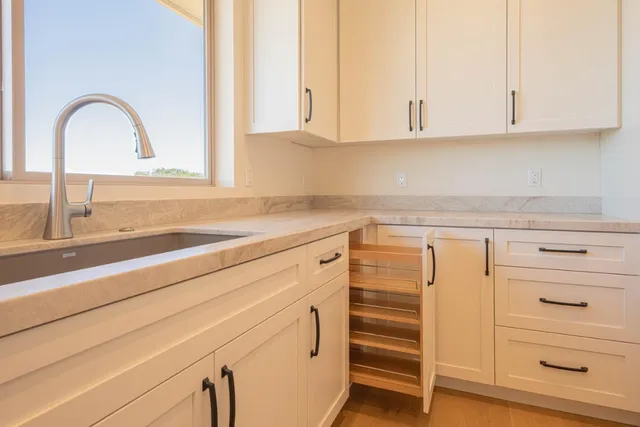 a kitchen with appliances cabinets and a sink
