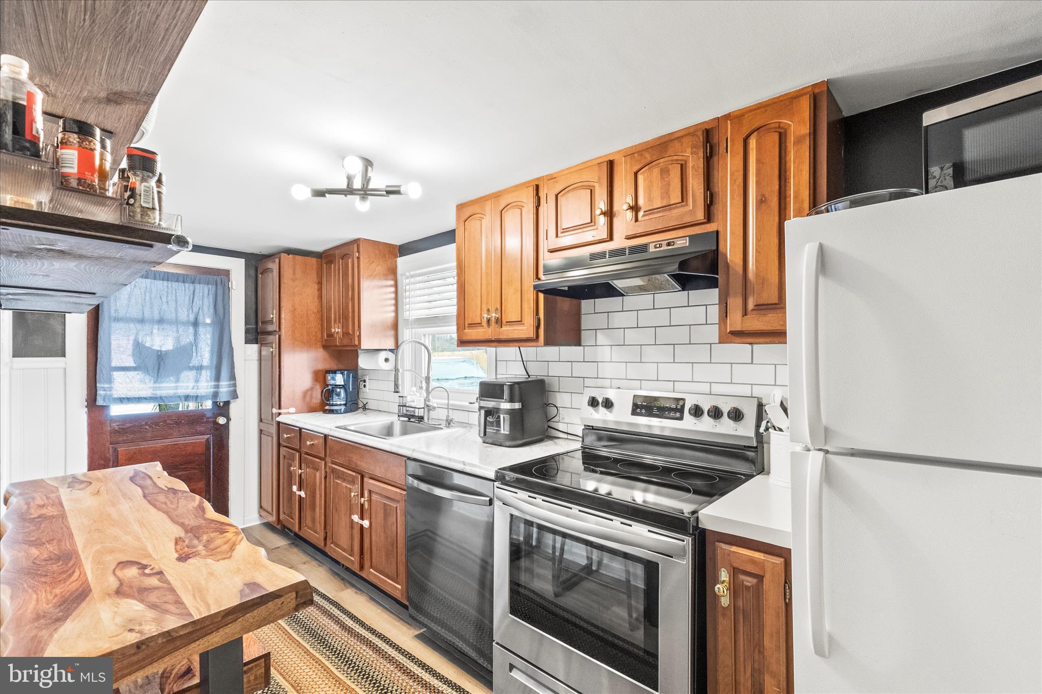 1709 Jefferson Road Spring Grove, PA 17362 - Photo 5 of 39 a kitchen with stainless steel appliances granite countertop a stove a sink and a refrigerator