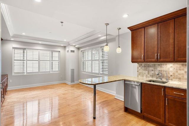 a spacious bathroom with a tub sink and mirror
