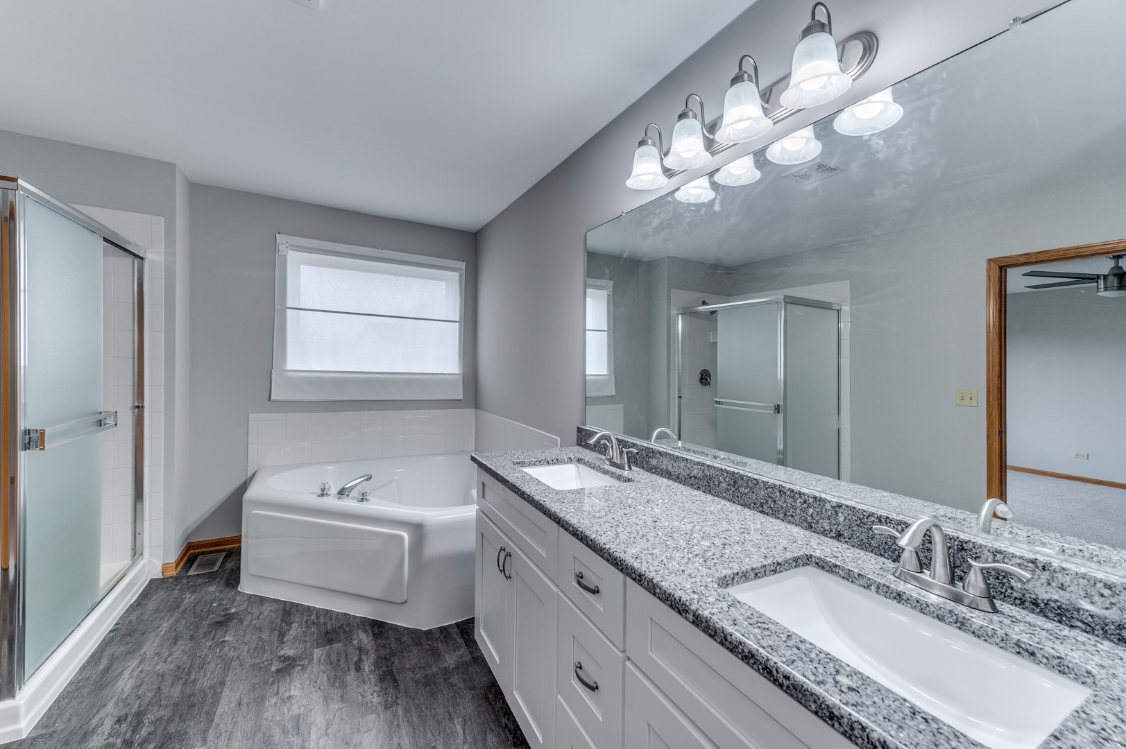 1809 Lake Shore Drive Romeoville, IL 60446 - Photo 22 of 30 a spacious bathroom with a granite countertop double vanity sink a mirror and a bathtub