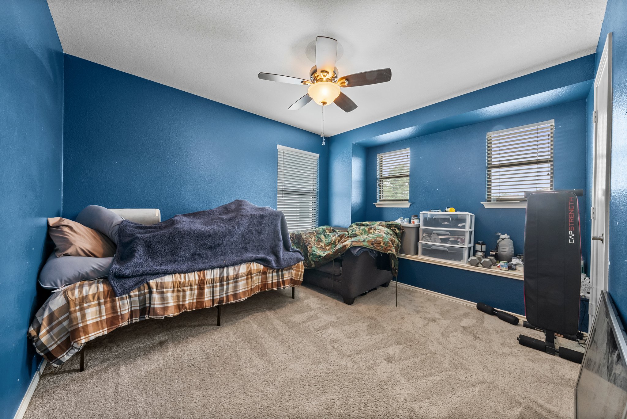 6829 Walkup Lane Austin, TX 78747 - Photo 12 of 18 A comfortable bedroom with soft carpeting and ample natural light invites restful relaxation.