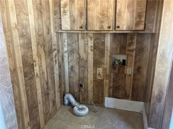 a view of a hallway with a door and wooden door