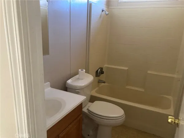 a kitchen with stainless steel appliances granite countertop a refrigerator a stove and a sink with wooden cabinets