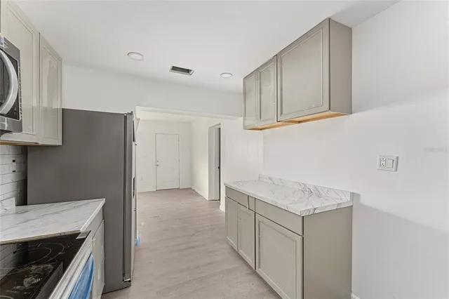 a kitchen with cabinets and a stove