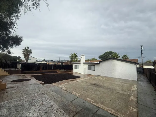 a front view of a house with a garden and yard
