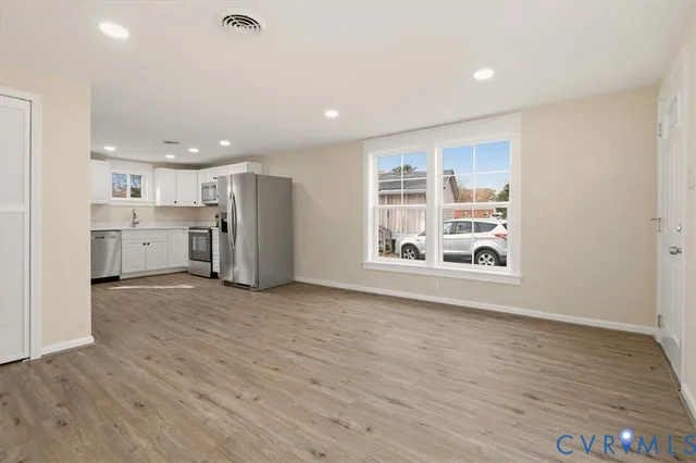 a view of a kitchen with a sink and a large window