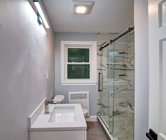 a bathroom with a sink a mirror and shower