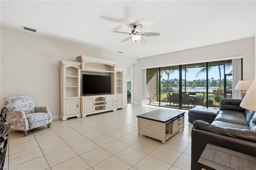 4194 Amelia Way Naples, FL 34119 - Photo 12 of 44 a living room with furniture and a flat screen tv