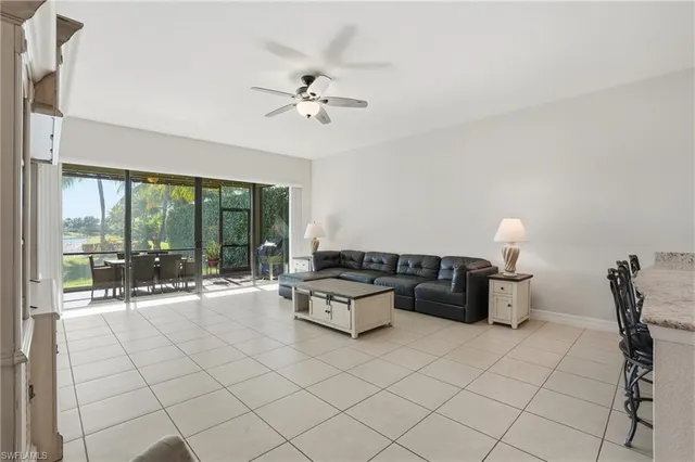 a living room with furniture and a floor to ceiling window