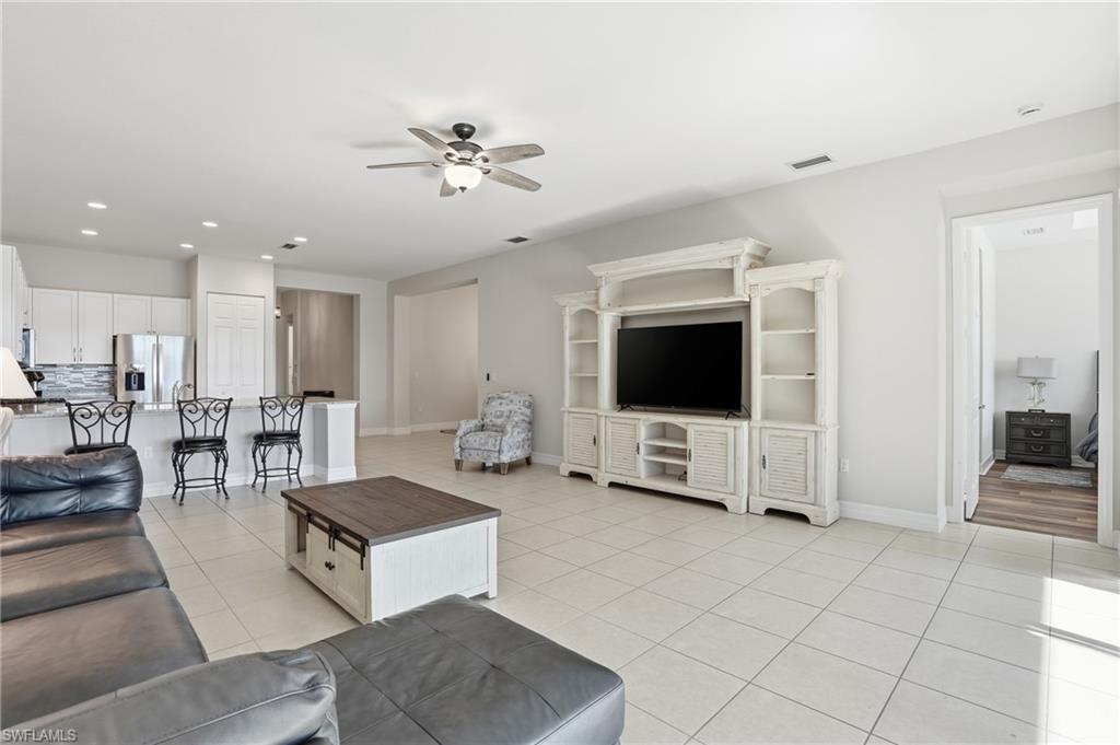 4194 Amelia Way Naples, FL 34119 - Photo 15 of 44 a living room with furniture and a flat screen tv