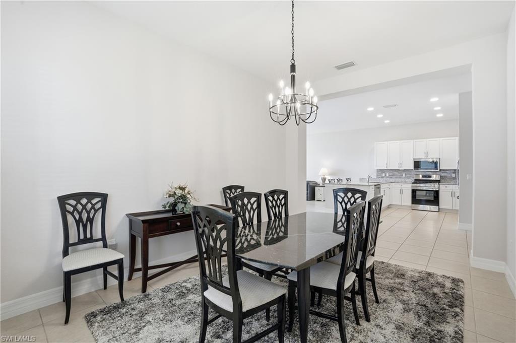 4194 Amelia Way Naples, FL 34119 - Photo 16 of 44 a view of a dining room with furniture