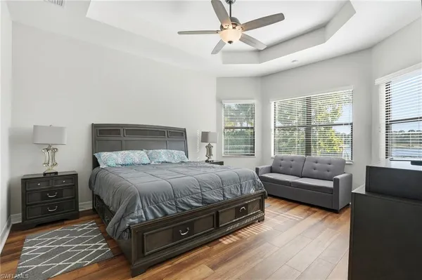 a bedroom with a bed a couch and a window