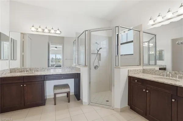 a spacious bathroom with a granite countertop sink mirror and a