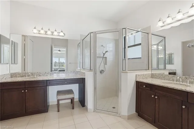 a spacious bathroom with a granite countertop sink mirror and a