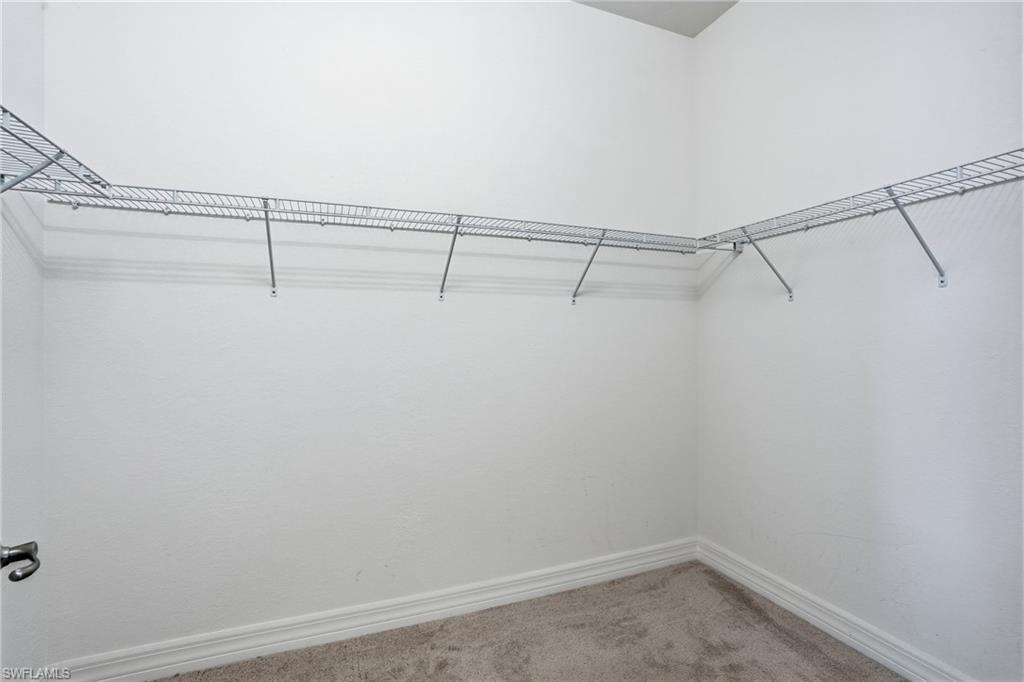 4194 Amelia Way Naples, FL 34119 - Photo 24 of 44 a view of a room with racks on the wall
