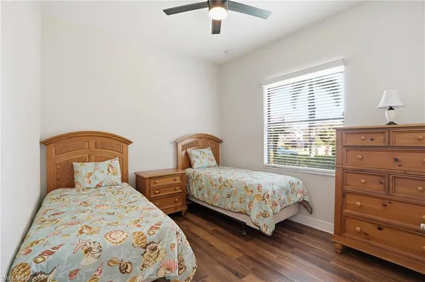 a bedroom with two beds and a dresser