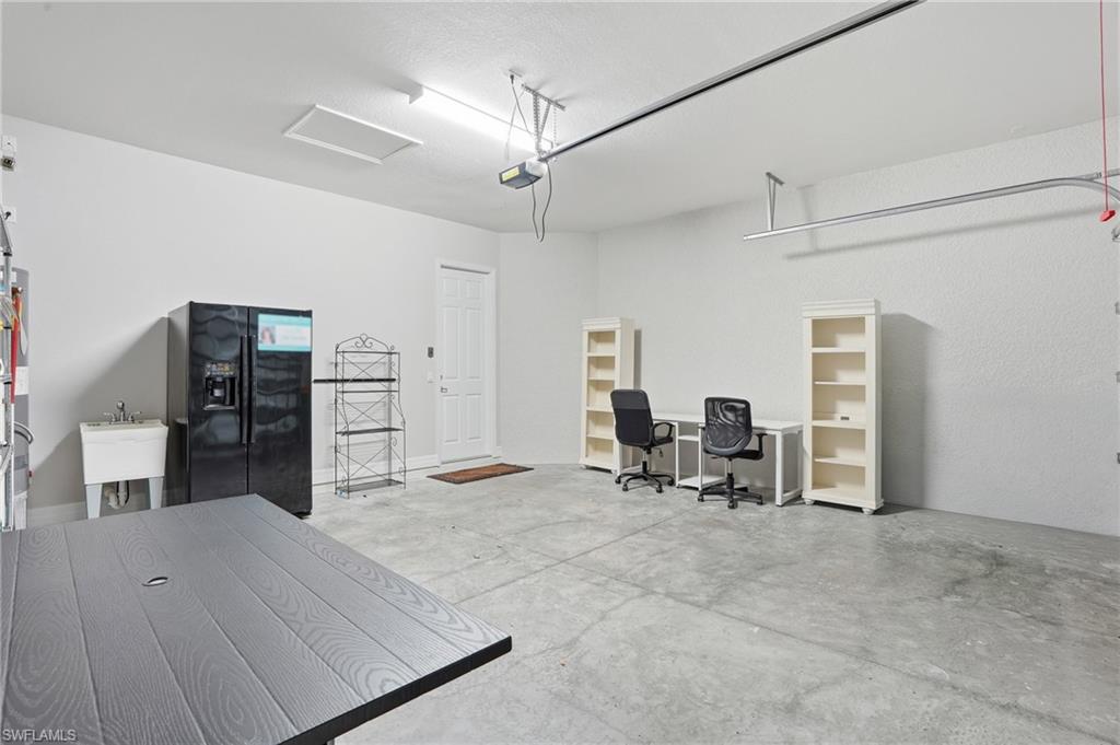 4194 Amelia Way Naples, FL 34119 - Photo 34 of 44 a view of a workspace with furniture and a chair