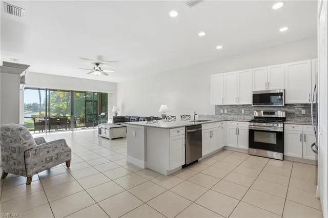 a kitchen with granite countertop cabinets and steel stainless steel appliances