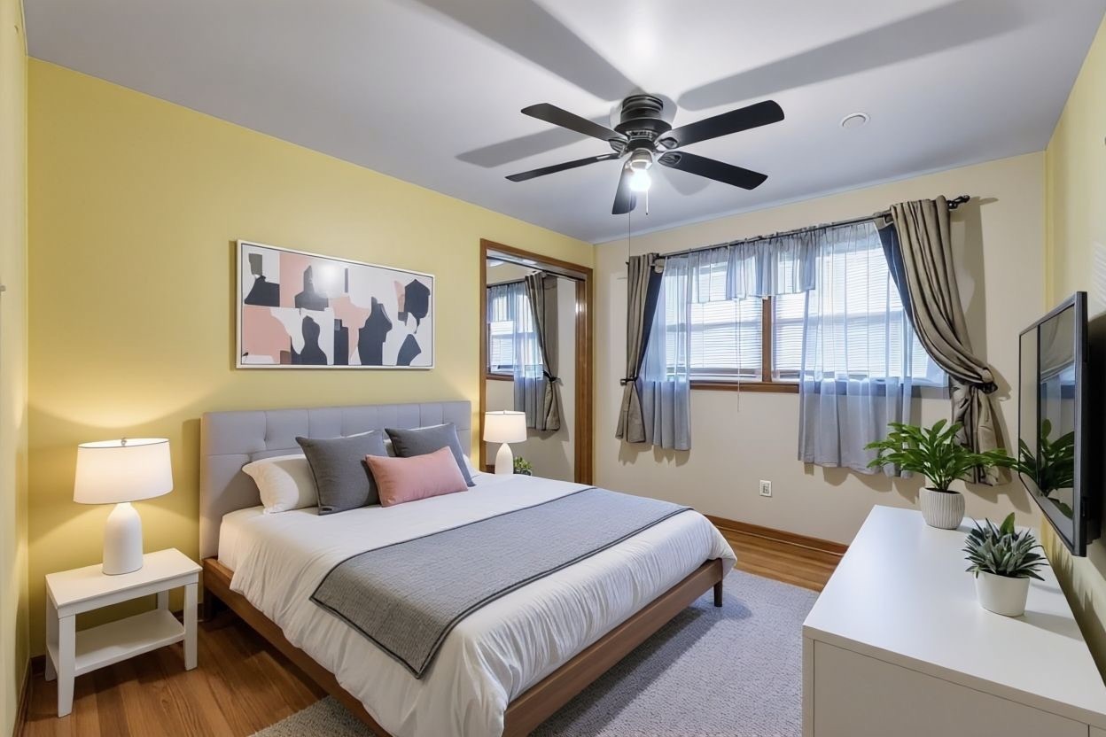 2117 West 71st Place Chicago, IL 60636 - Photo 16 of 31 a bedroom with a large bed and a chandelier