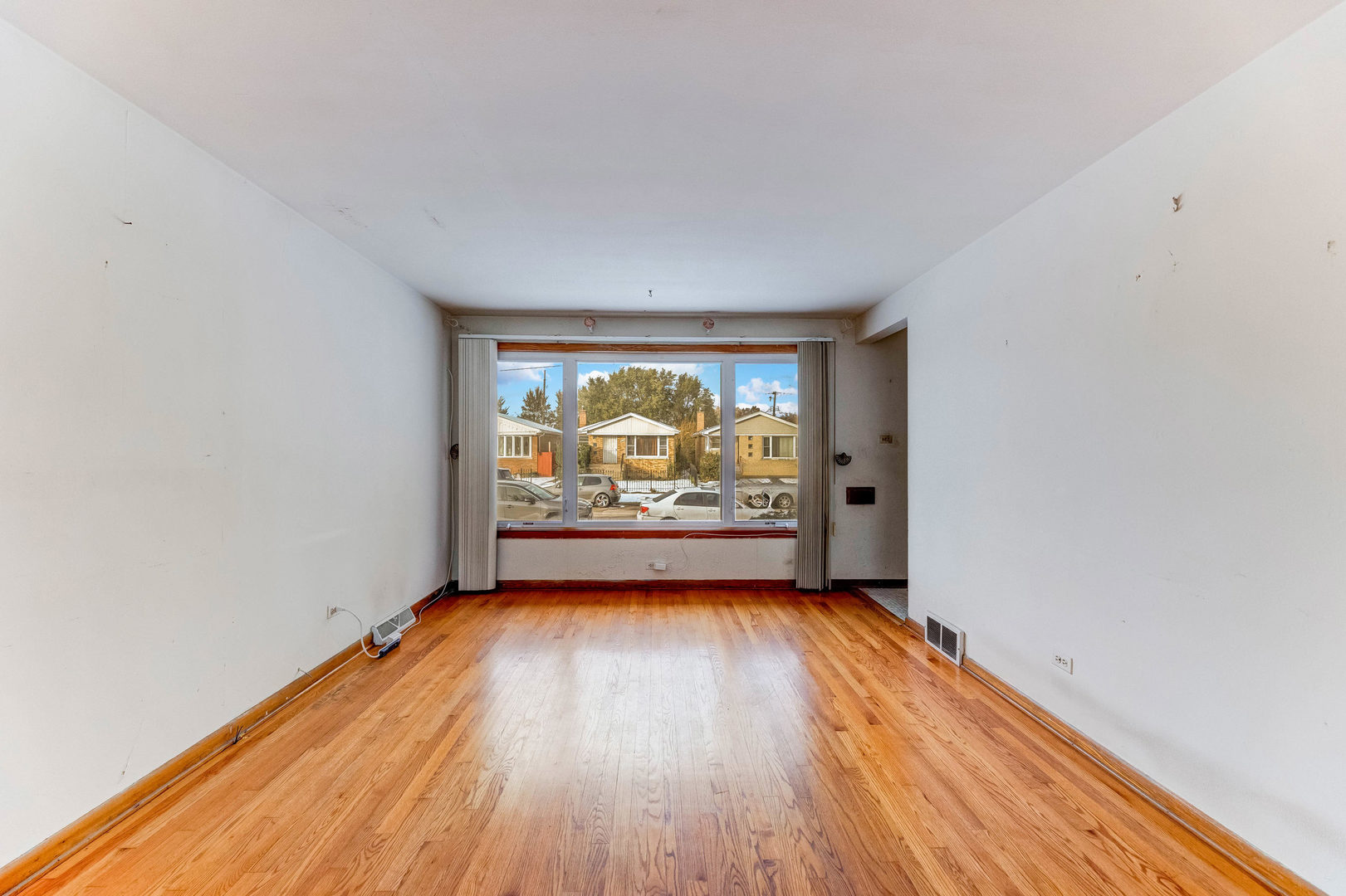 2117 West 71st Place Chicago, IL 60636 - Photo 6 of 31 wooden floor in an empty room with a window