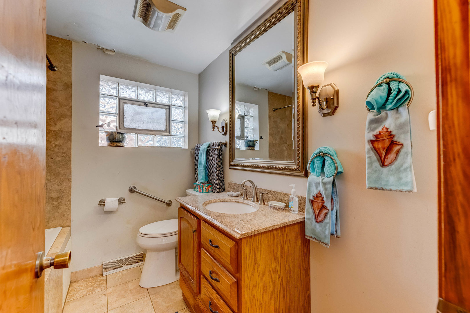 2117 West 71st Place Chicago, IL 60636 - Photo 7 of 31 a bathroom with a toilet sink and mirror