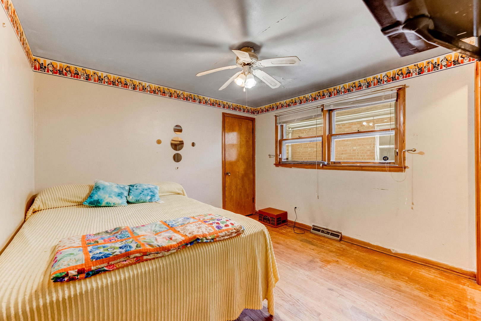 2117 West 71st Place Chicago, IL 60636 - Photo 9 of 31 a bedroom with a bed and a chandelier