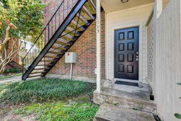 a view of front door of house with stairs