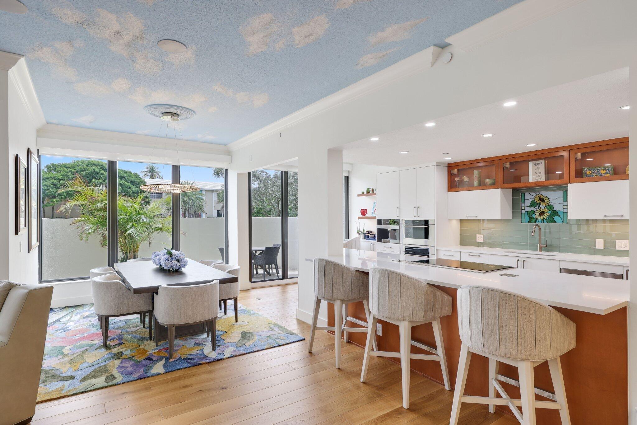 3900 North Ocean Boulevard, Unit LANAI Delray Beach, FL 33483 - Photo 12 of 40 a dining room with furniture a rug and a floor to ceiling window