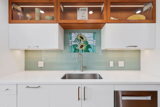 a kitchen with a sink a counter top space and a window