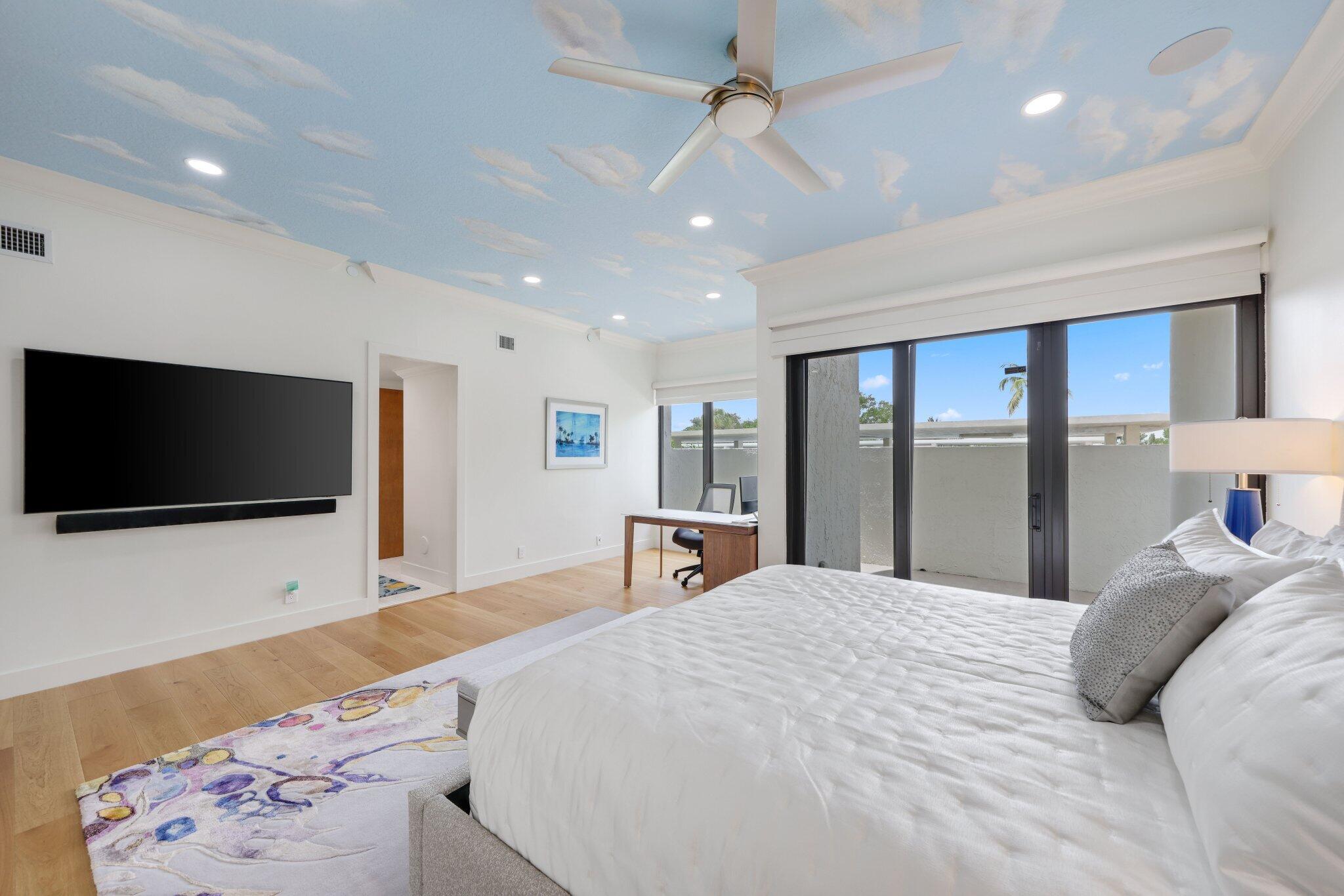 3900 North Ocean Boulevard, Unit LANAI Delray Beach, FL 33483 - Photo 19 of 40 a bedroom with a bed and a flat screen tv