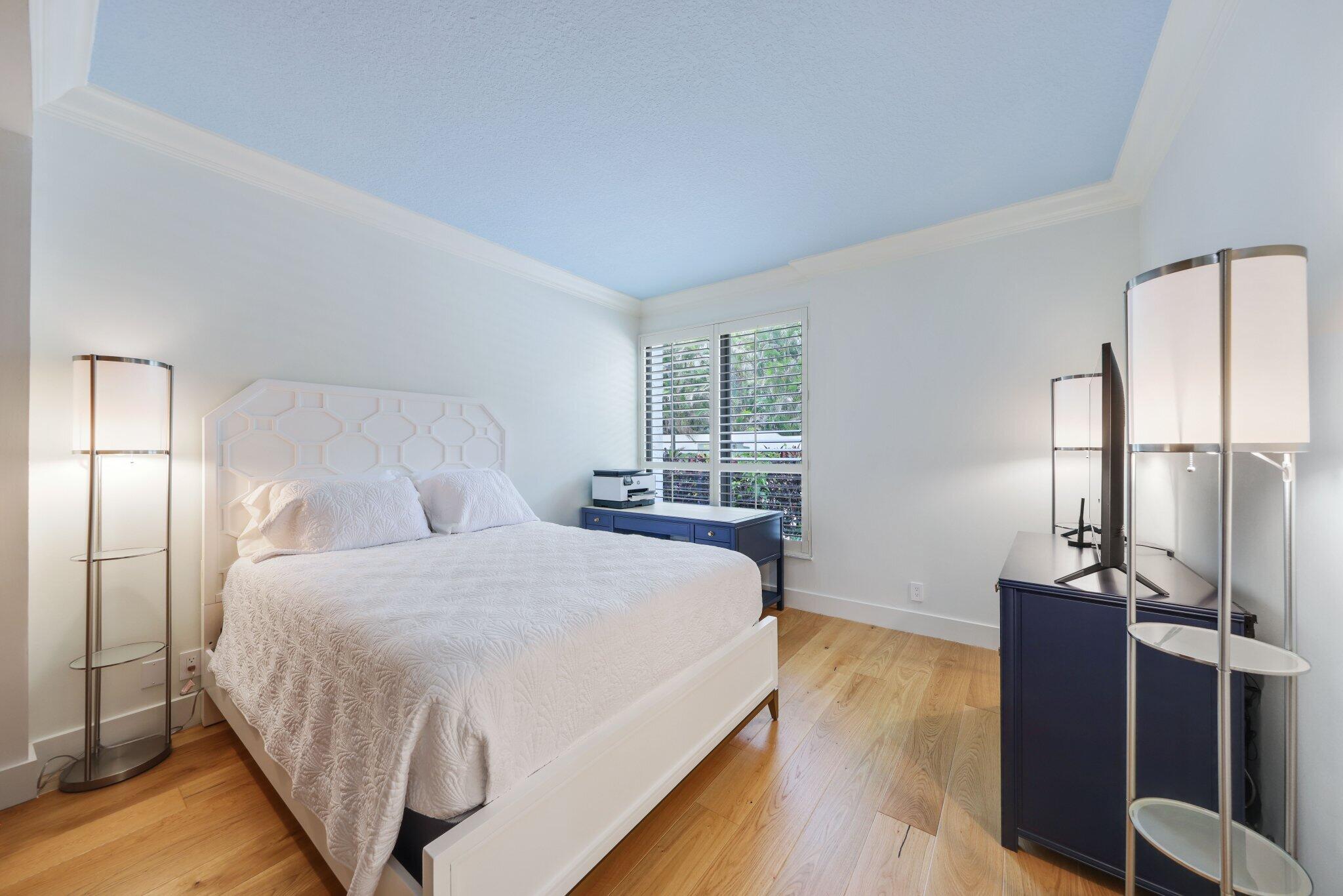 3900 North Ocean Boulevard, Unit LANAI Delray Beach, FL 33483 - Photo 27 of 40 a bedroom with a bed and wooden floor