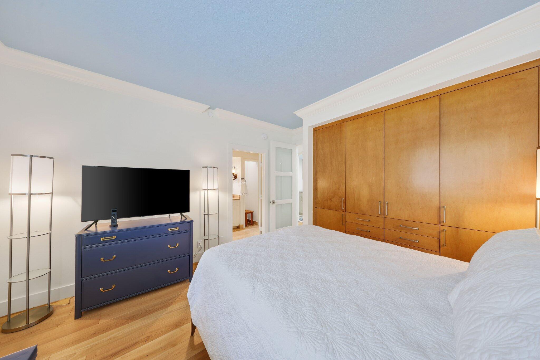 3900 North Ocean Boulevard, Unit LANAI Delray Beach, FL 33483 - Photo 28 of 40 a bedroom with a bed and a flat screen tv