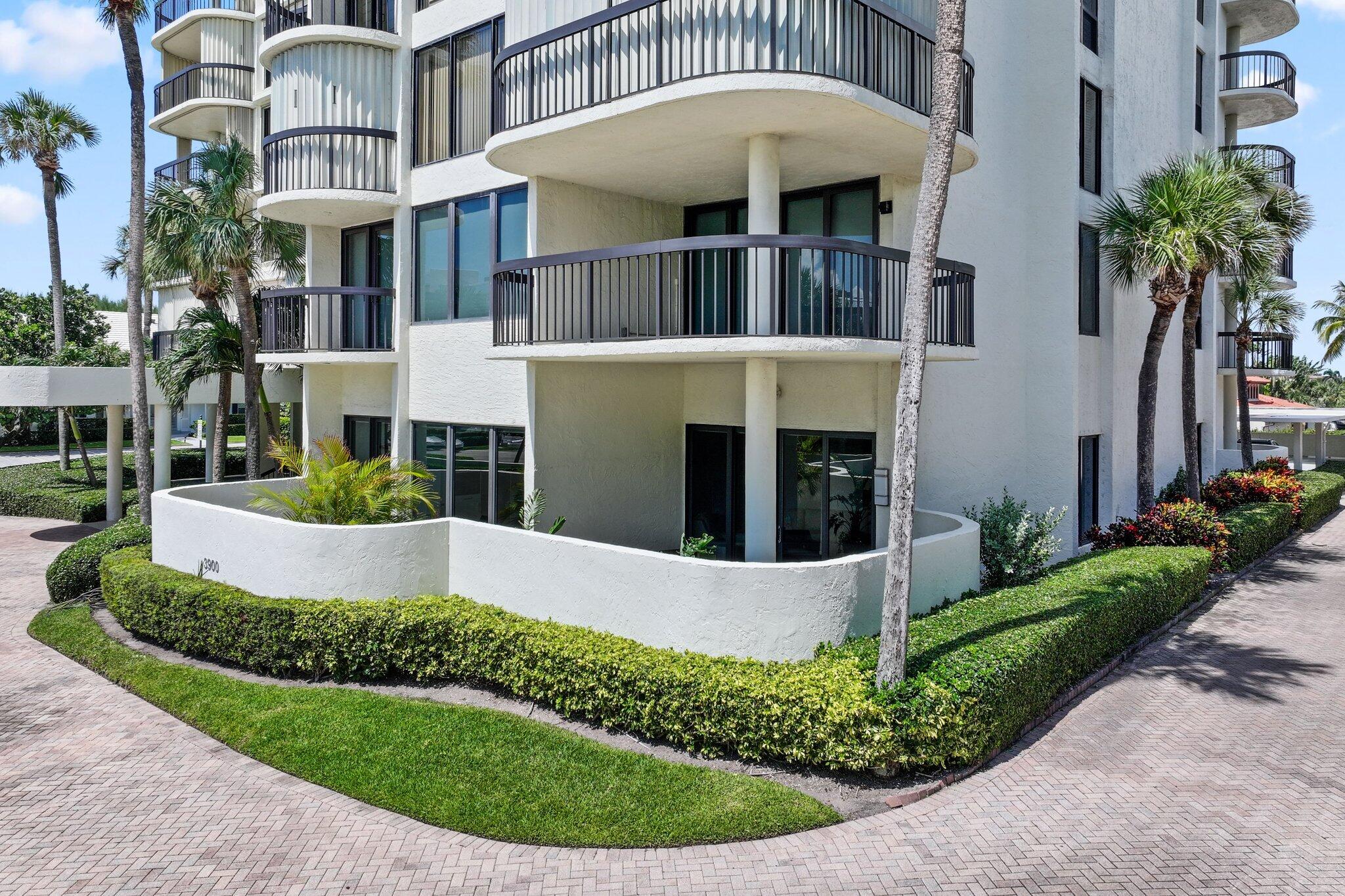 3900 North Ocean Boulevard, Unit LANAI Delray Beach, FL 33483 - Photo 36 of 40 a view of a house with a small yard and potted plants
