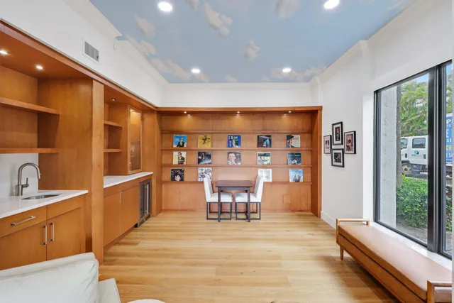 a view of a kitchen with furniture and wooden floor