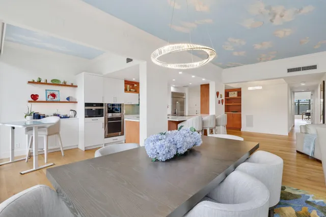 a kitchen with stainless steel appliances kitchen island granite countertop a table and chairs