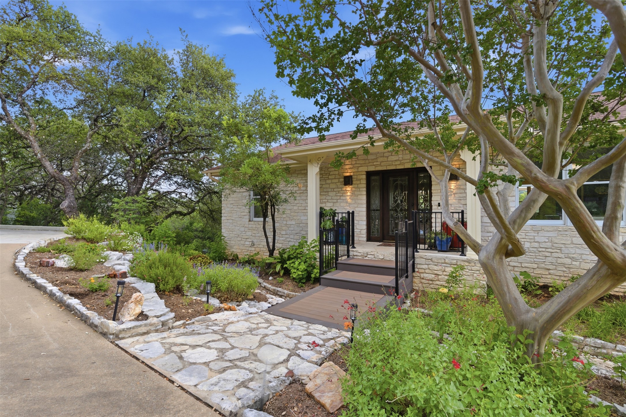 1504 Twilight Ridge Drive Austin, TX 78746 - Photo 2 of 30 Wildflowers and Texas Limestone welcome you home, and the big views out back keep you smiling.