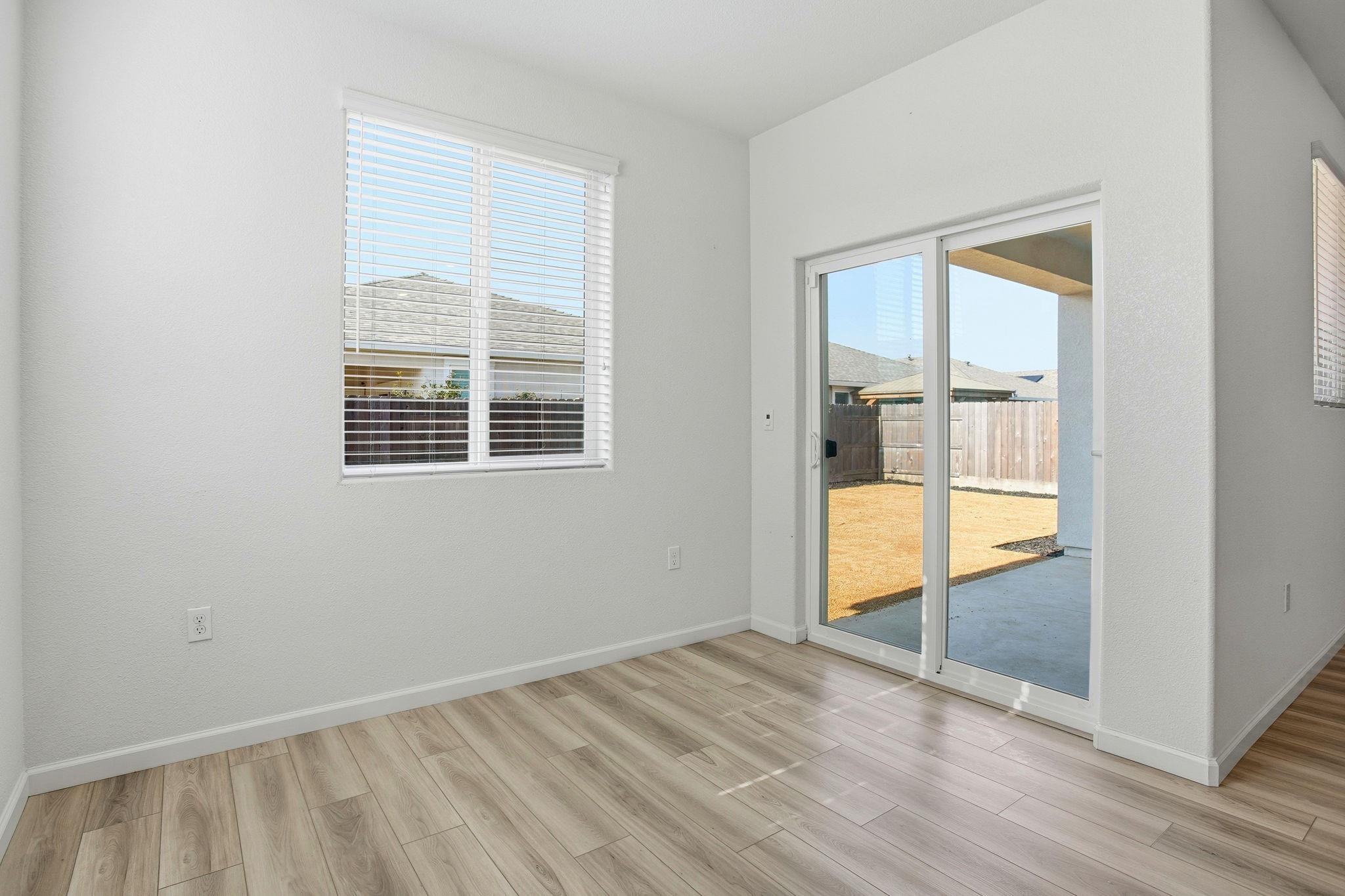 2055 Stars Drive Rio Vista, CA 94571 - Photo 16 of 43 an empty room with wooden floor and windows
