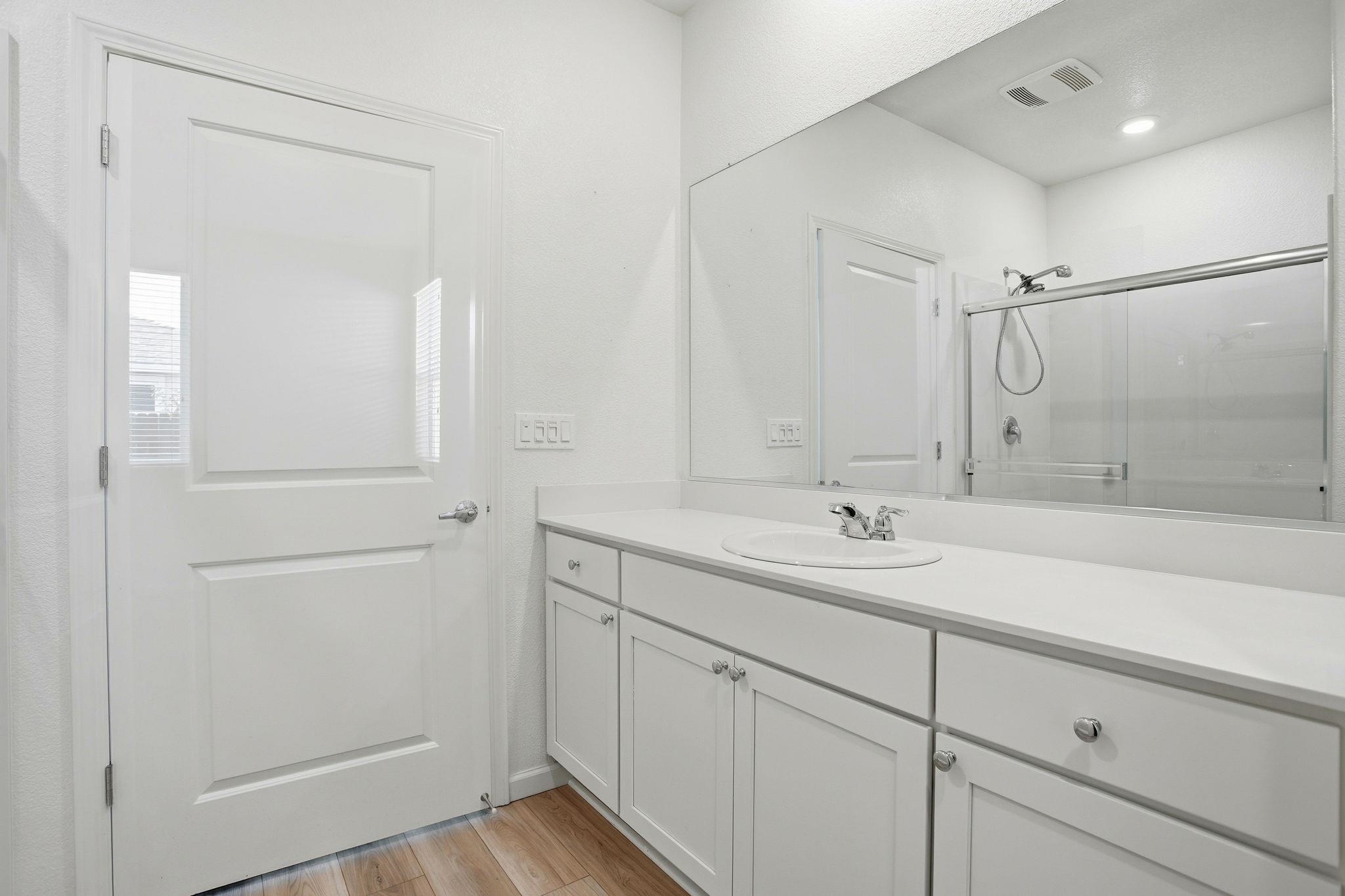 2055 Stars Drive Rio Vista, CA 94571 - Photo 25 of 43 a bathroom with a shower sink and mirror